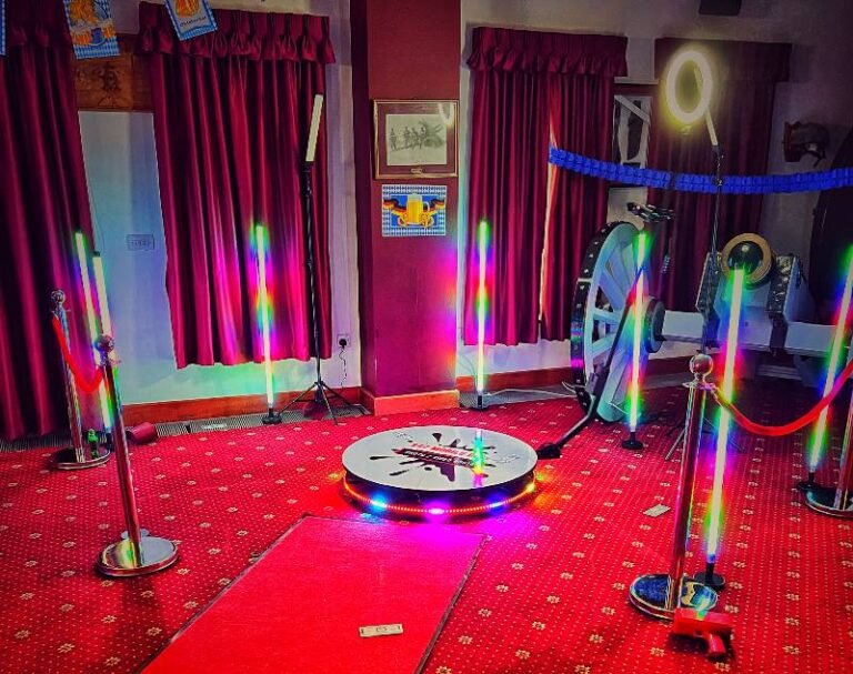 360 Video Booth at an event with red carpet with the stage lit up