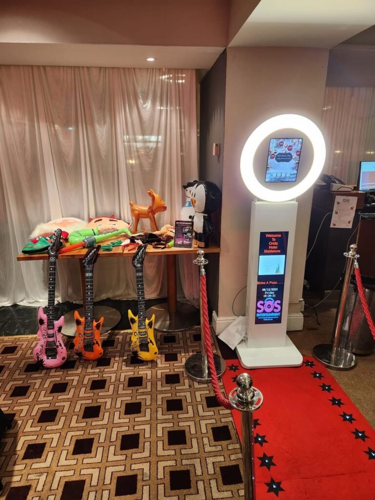 Photo Booths at Weddings with accessories and red carpet leading up to the booth.