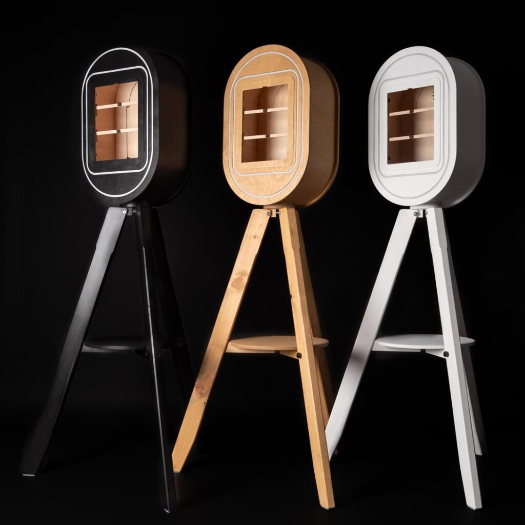 Black, wooden and white Vintage Photo Booths For Sale photographed against a black background.