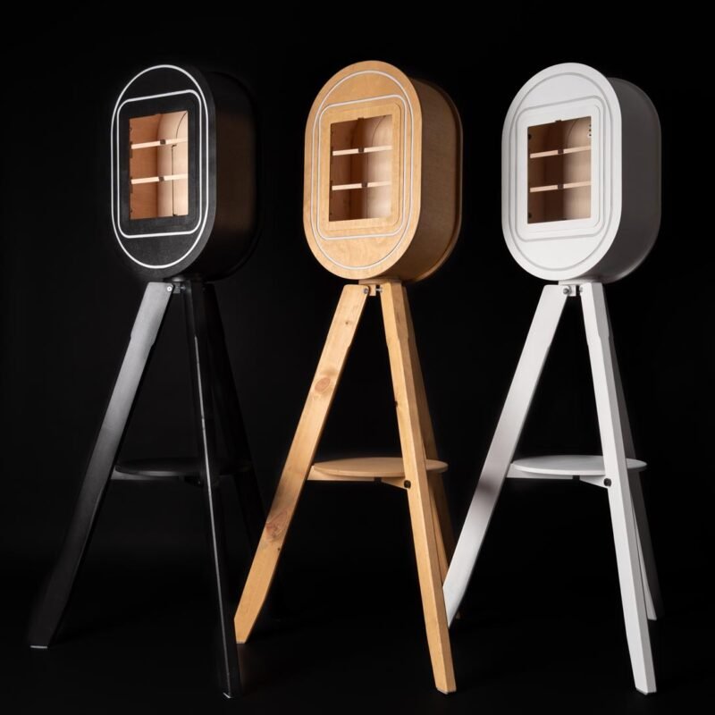 Black, wooden and white Vintage Photo Booths For Sale photographed against a black background.