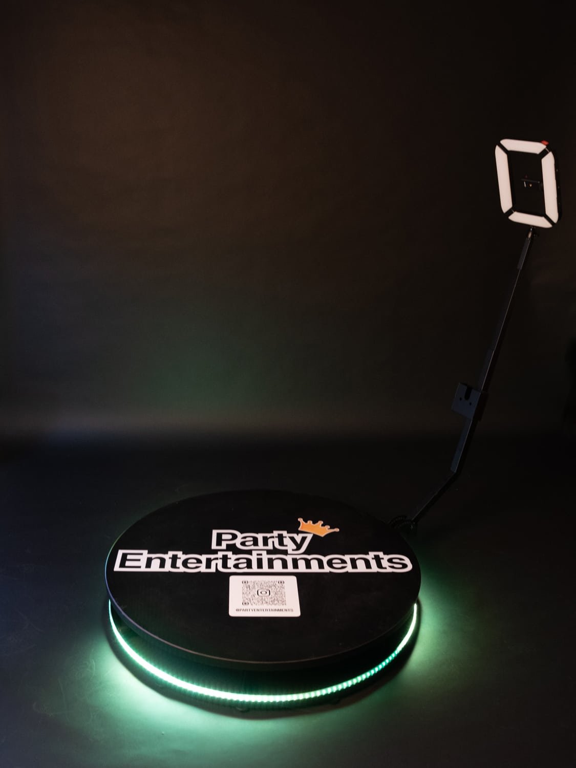 360 Photo Booths on a black background with a lit up green base