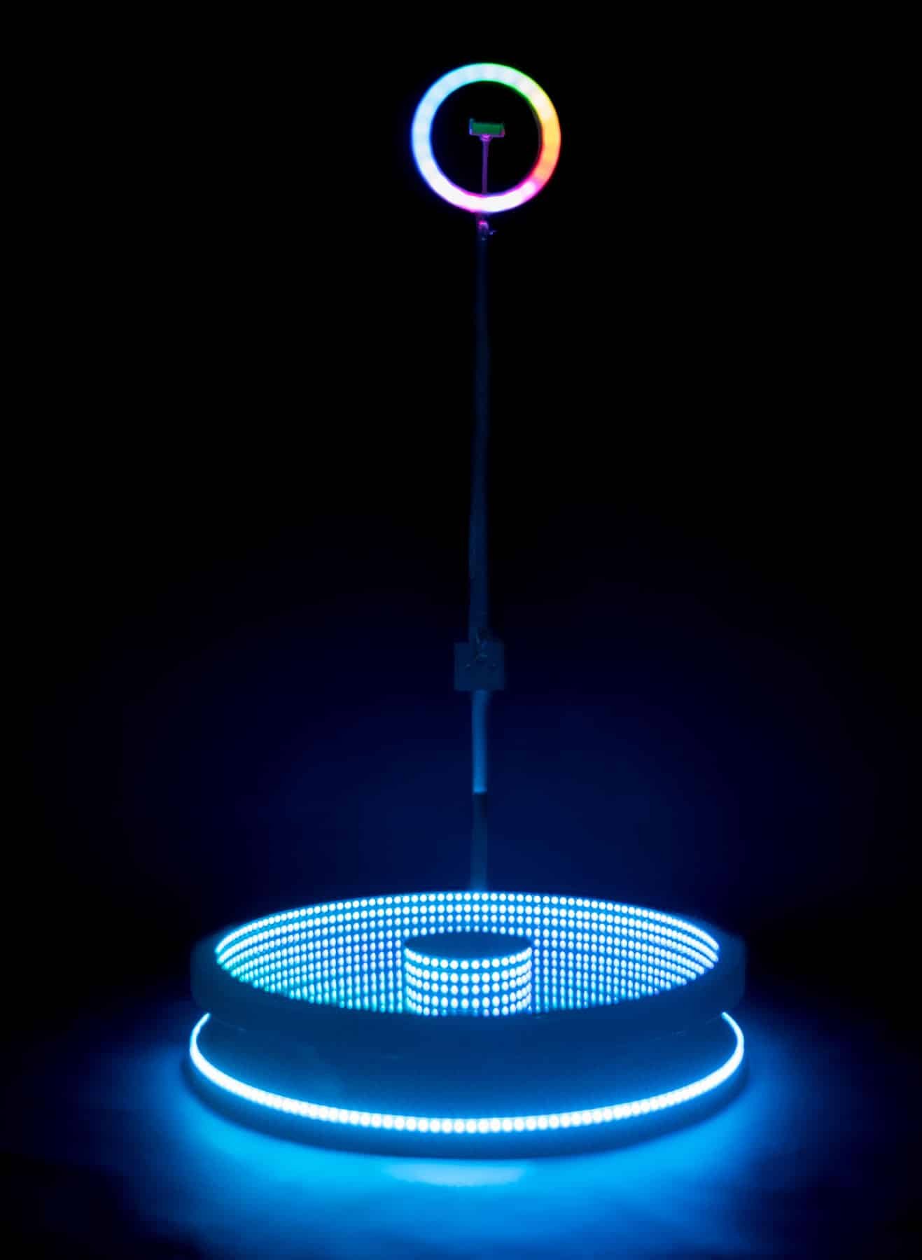 360 Glass Video Booth on black background lit up in blue
